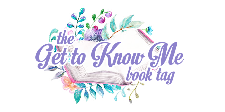 'Get to Know Me book tag'; text is light purple/lavender, outlined in white, overlaying an open book on top of floral/greenery; all is illustrated