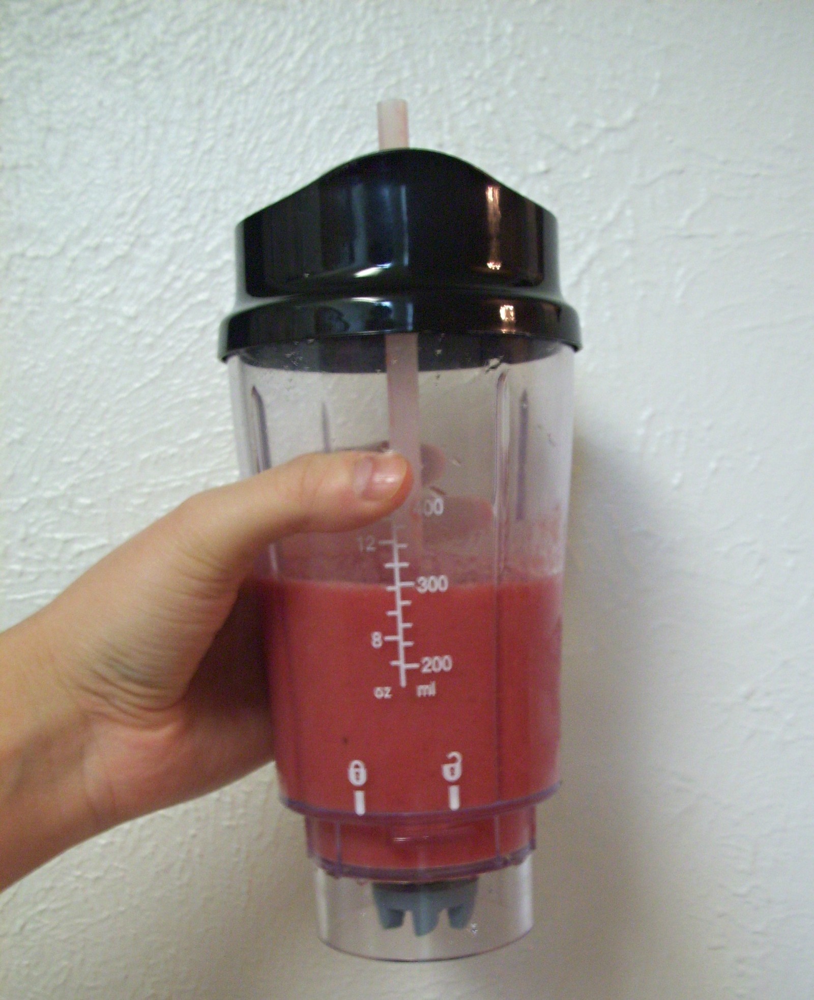 Photo of titular smoothie being held in front of a white wall