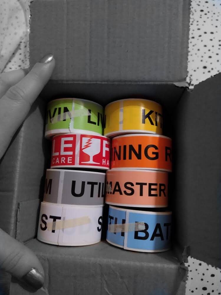 Box of packing labels; black-and-white with labels in color only