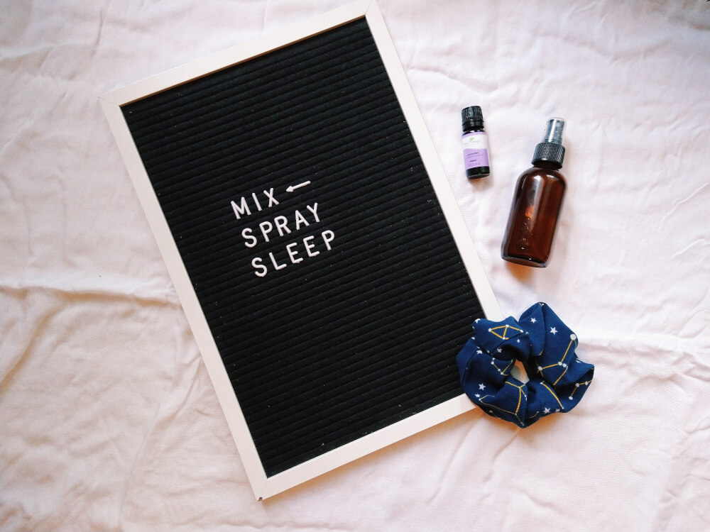 "Mix Sleep Spray" on letter board; constellation scrunchie, lavender essential oil, amber spray bottle