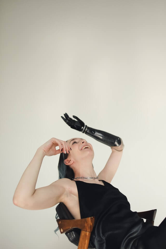 Woman with black prosthetic arm