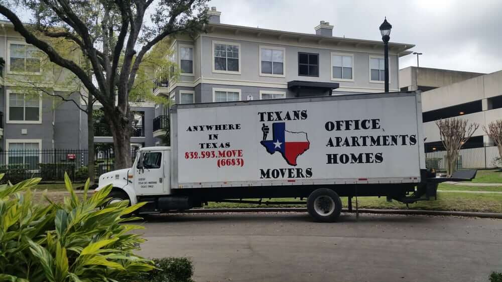 Texans Movers moving truck in front of apartments